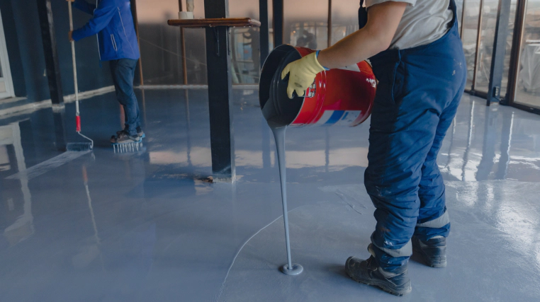 man pouring epoxy on floor millersburg pa